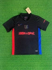 Barcelona x Travis Scott Away Jersey 2025/26 – Black with Cactus Jack red graffiti and red-blue side panels